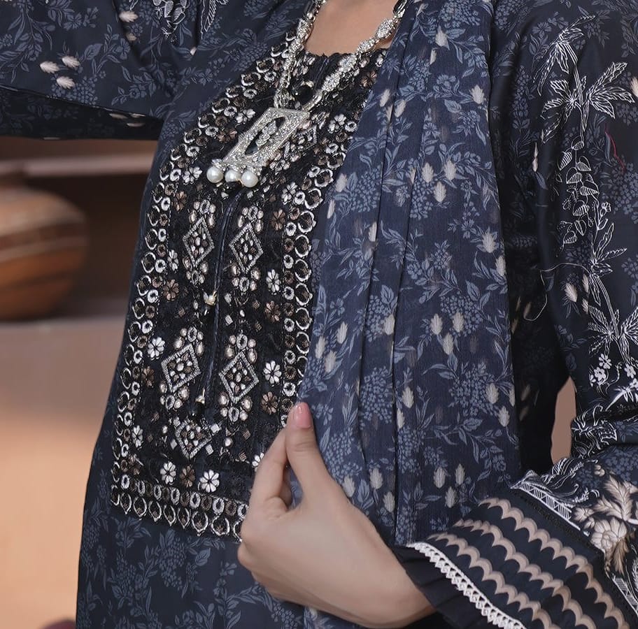A close detail of a slate-navy kurta set with a black embroidered yoke: the black embroidered yoke and a silver necklace.