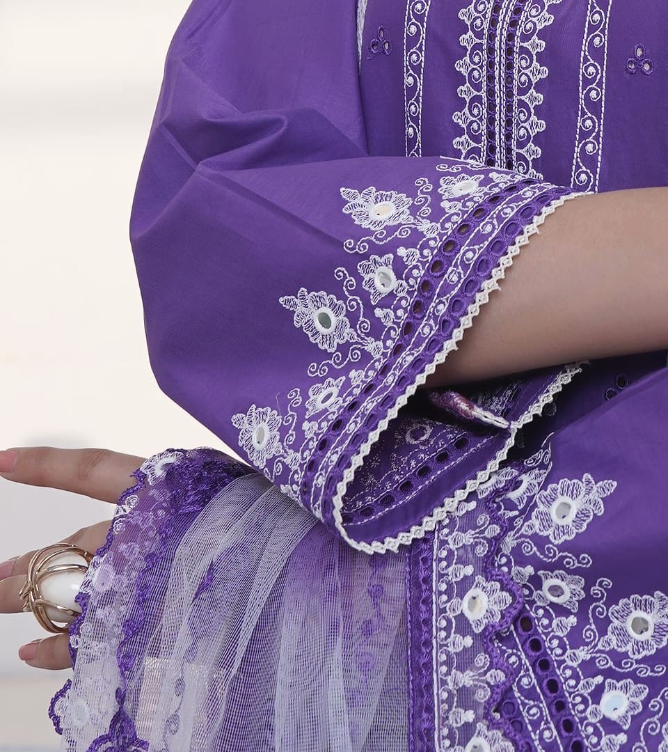A close detail of a violet kurta set with white lace and cuff embroidery and a net dupatta: the lace-edged embroidered cuff and the net dupatta.